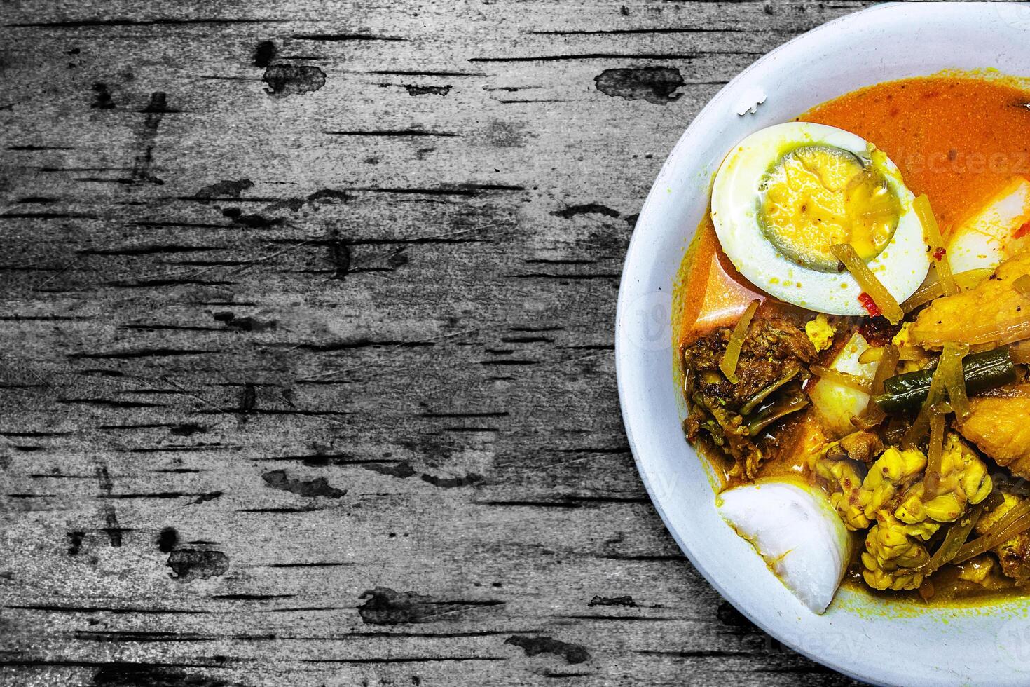 traditional food with coconut milk content in it. traditional food from Indonesia is ketupat sayur. in it there are various vegetable mixtures and thick coconut milk sauce. photo