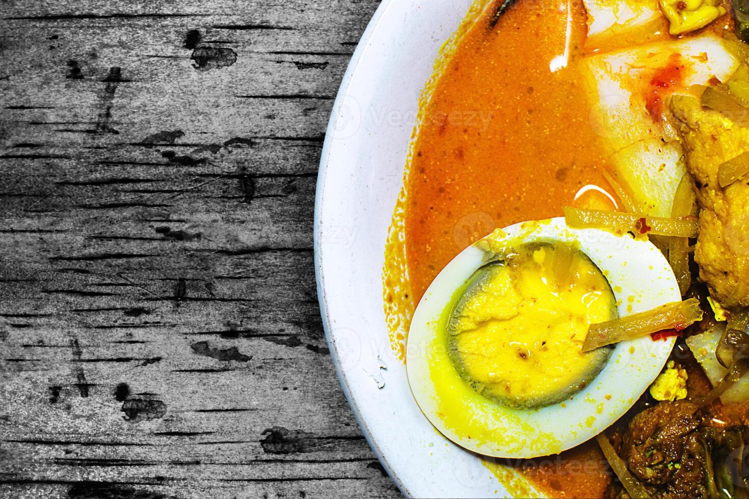traditional food with coconut milk content in it. traditional food from Indonesia is ketupat sayur. in it there are various vegetable mixtures and thick coconut milk sauce. photo