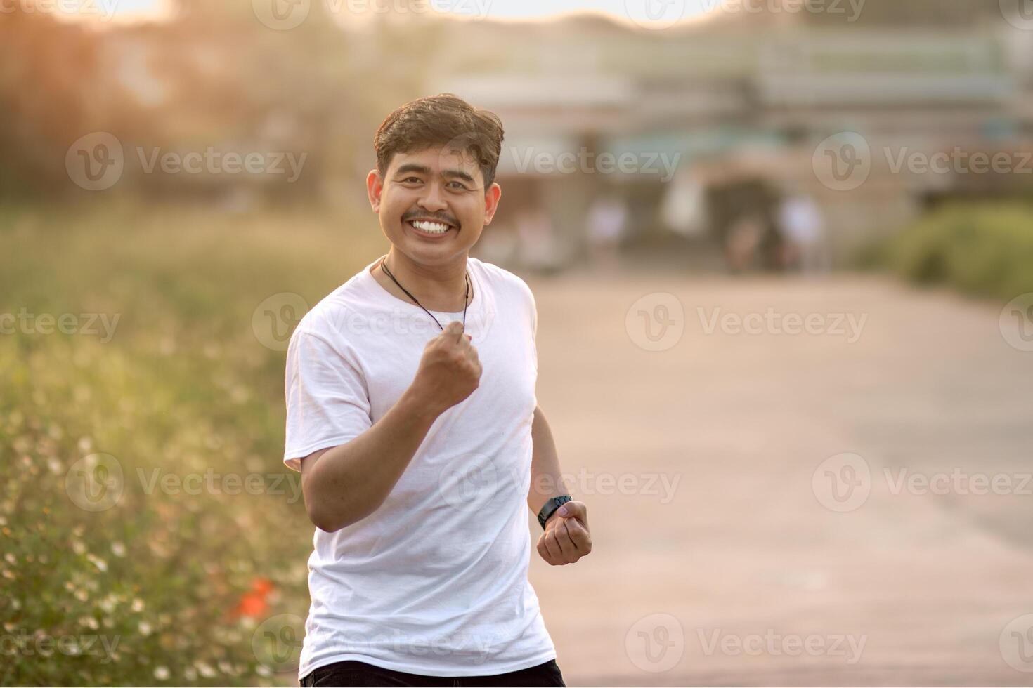 a man who stood and smiled goofily. The man acted like he was running. set in nature on a sunny afternoon. photo