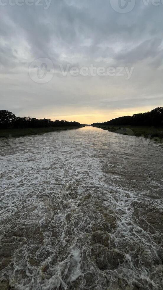 Flowing stream of dirty water in the river, river filled with dirty water after flood. Oder River, Poland photo
