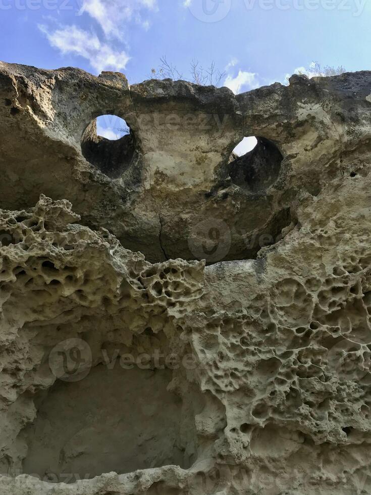 Natural rock in the form of a flying demon. Smiling bat. Bakla, Crimea. photo