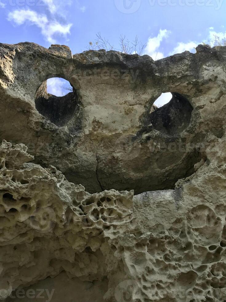 Natural rock in the form of a flying demon. Smiling bat. Bakla, Crimea. photo