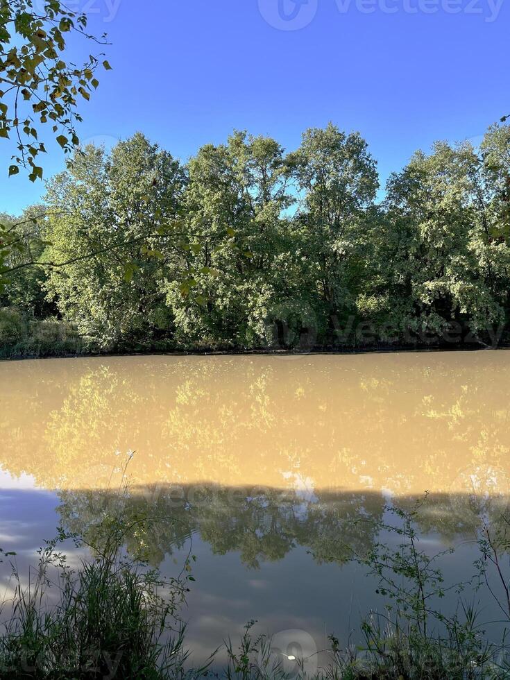 Flowing stream of dirty water in the river, river filled with dirty water after flood. Oder River, Poland photo