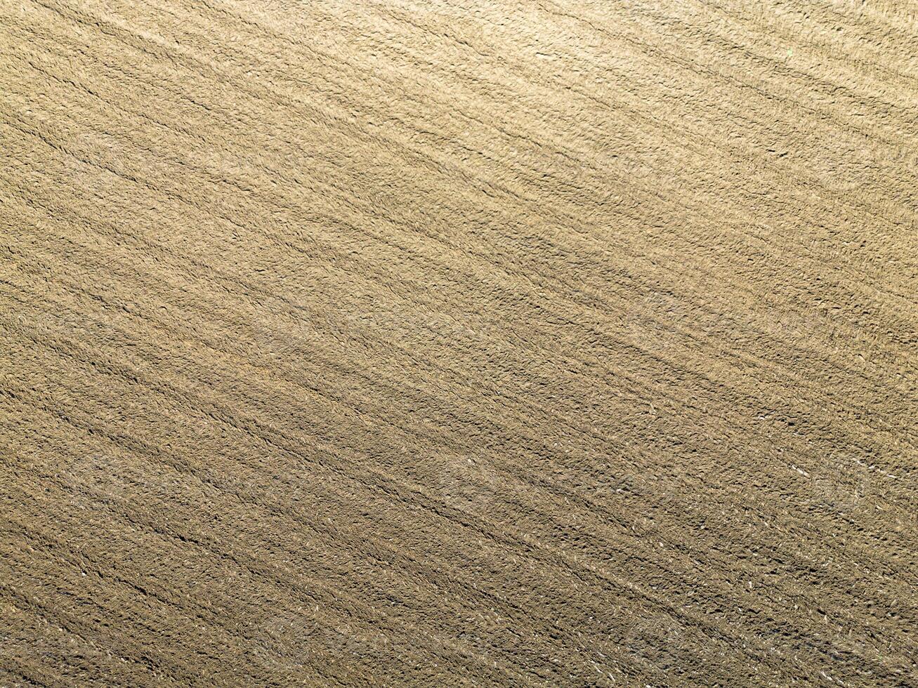 Plowed agricultural field, view from above, background. photo
