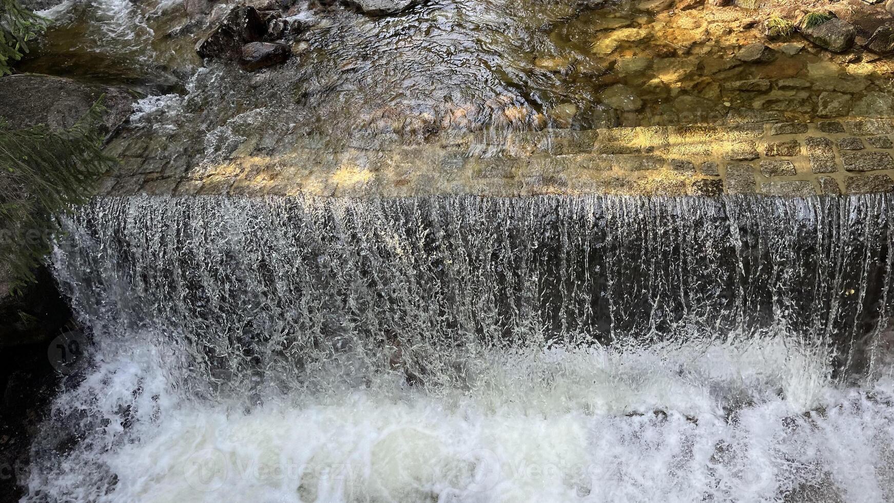 A small mountain river with a flow of water in the Polish mountains. Eastern Sudetes photo