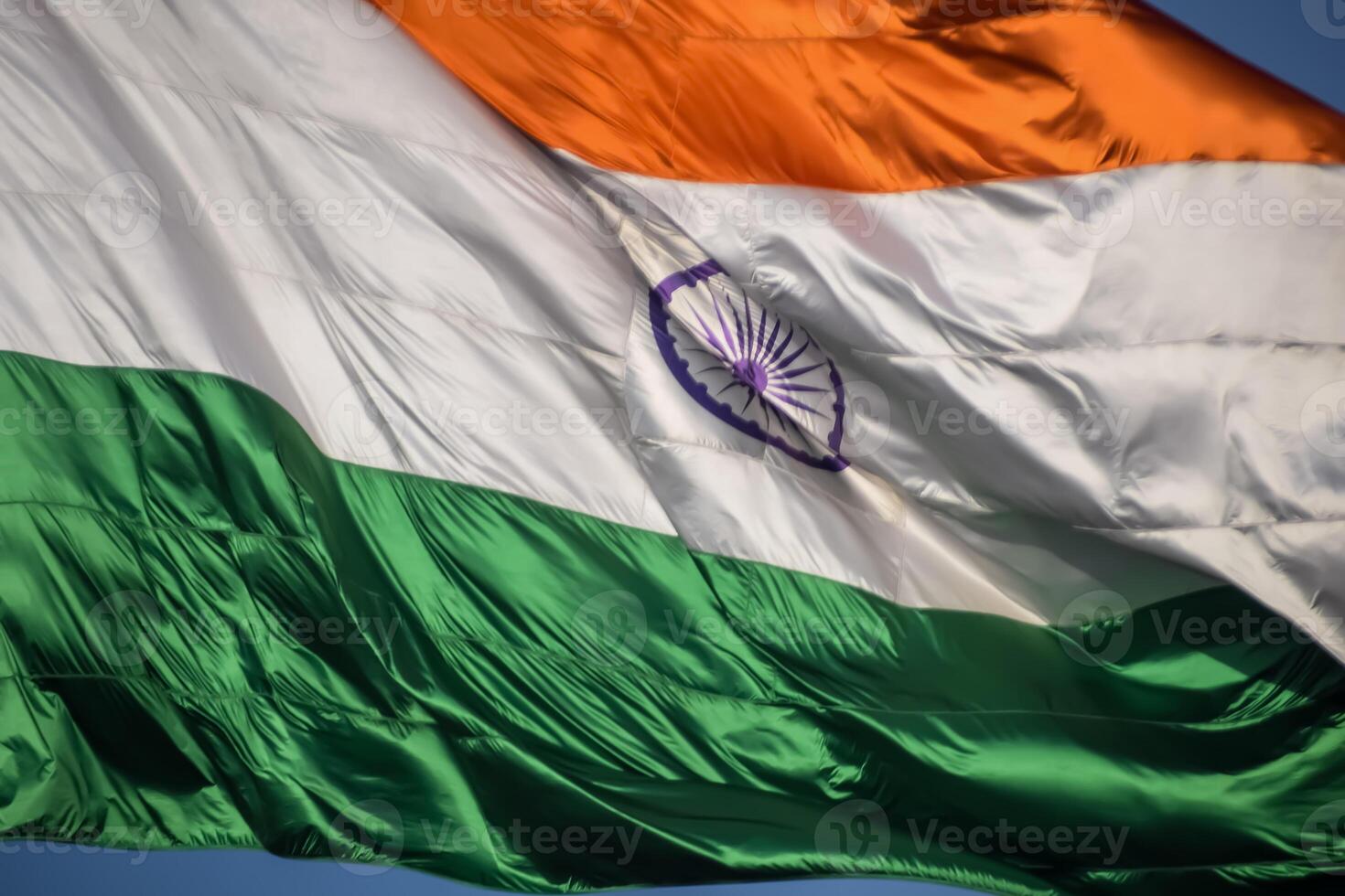 India flag flying high at Connaught Place with pride in blue sky, India flag fluttering, Indian Flag on Independence Day and Republic Day of India, tilt up shot, Waving Indian flag, Har Ghar Tiranga photo