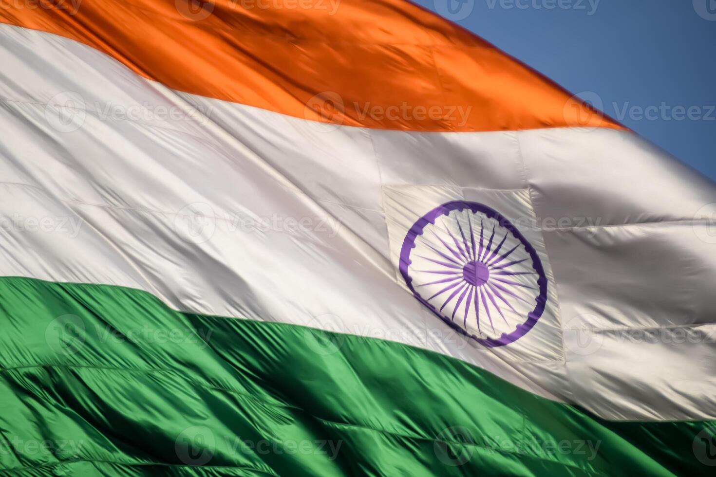 India flag flying high at Connaught Place with pride in blue sky, India flag fluttering, Indian Flag on Independence Day and Republic Day of India, tilt up shot, Waving Indian flag, Har Ghar Tiranga photo