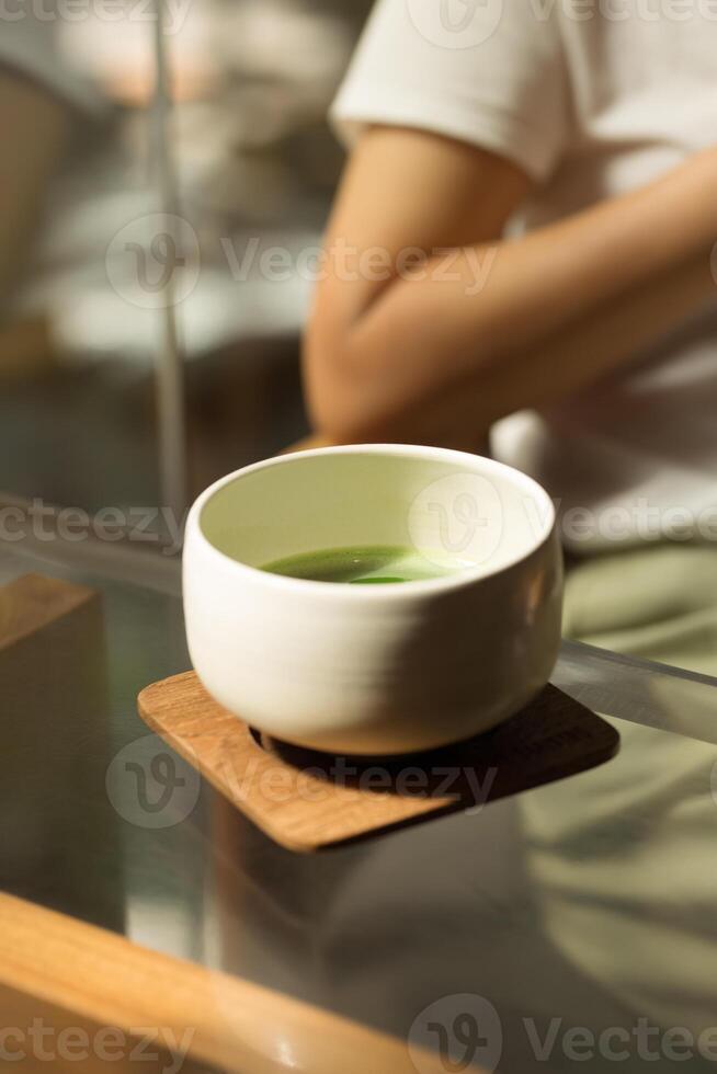 A serene moment captured with a ceramic bowl of matcha, reflecting tranquility. photo