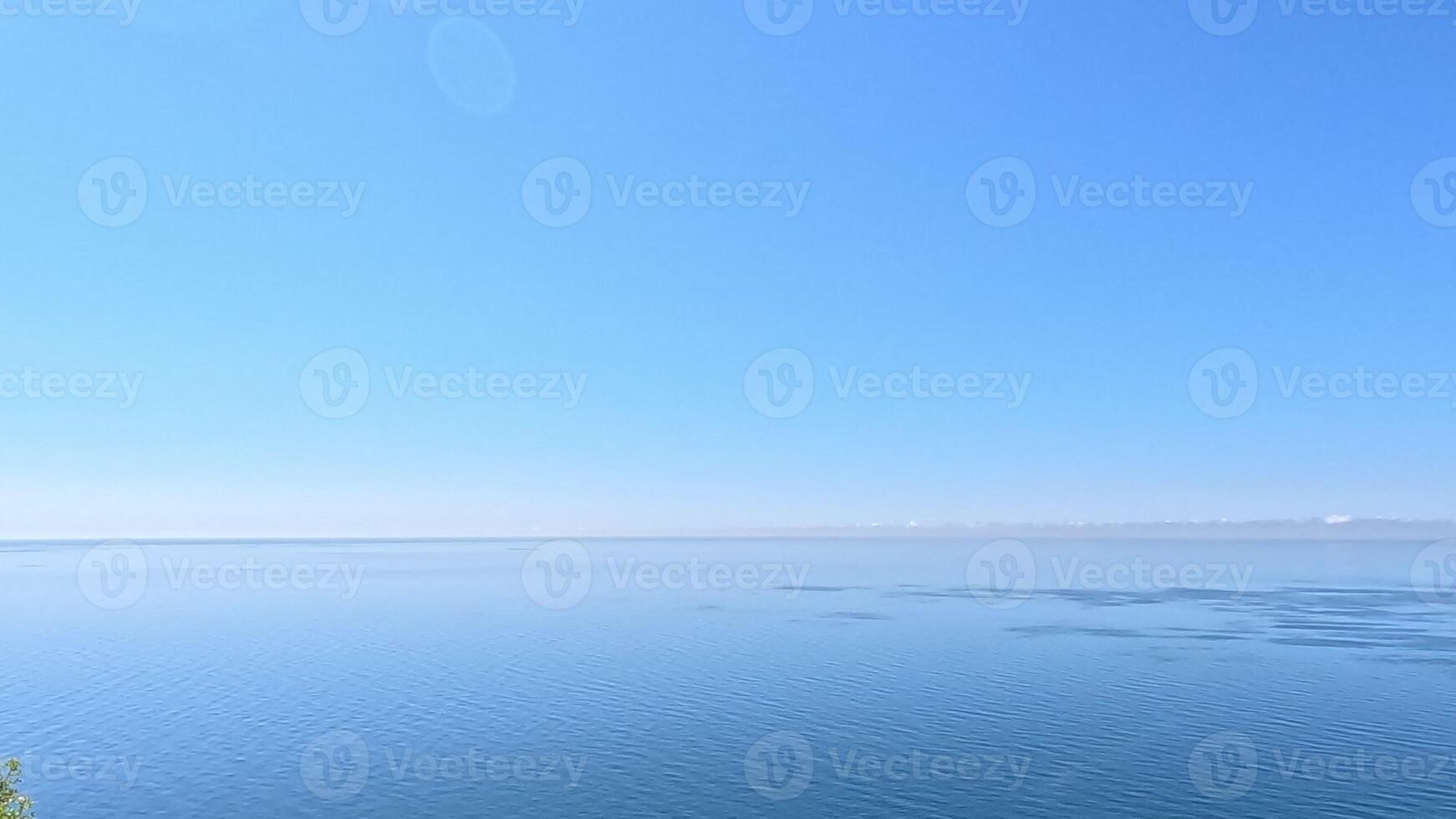 Aerial view on calm azure sea and volcanic rocky shores. Small waves on water surface in motion blur. Nature summer ocean sea beach background. Nobody. Holiday, vacation and travel concept photo