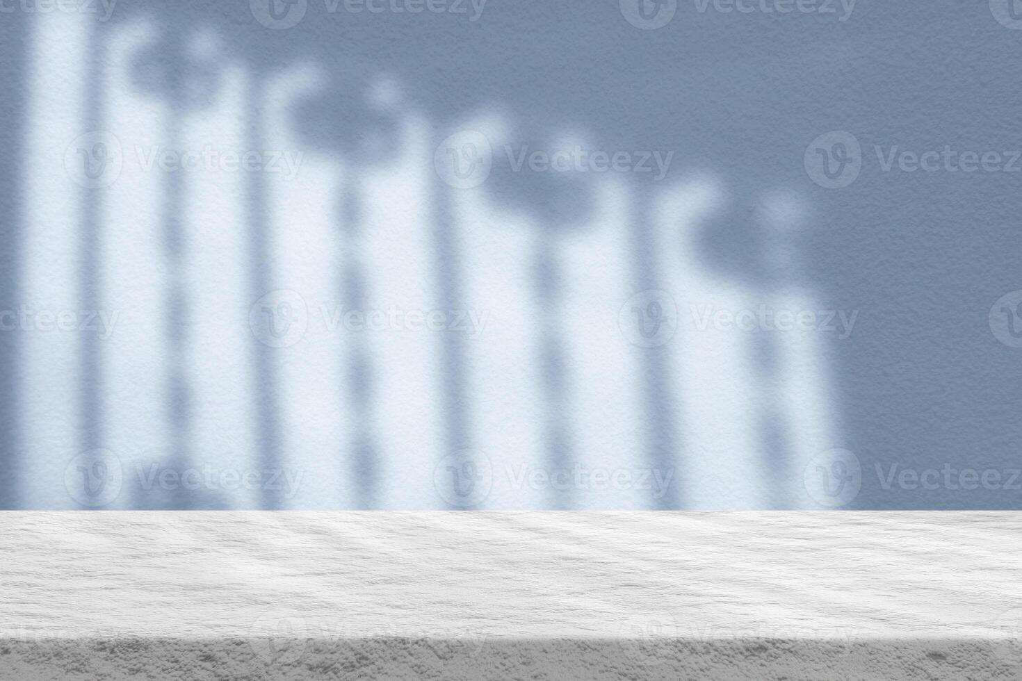 Stucco Table with Light Beam and Shadow via Wrought Iron Window on Coastal Blue Wall photo