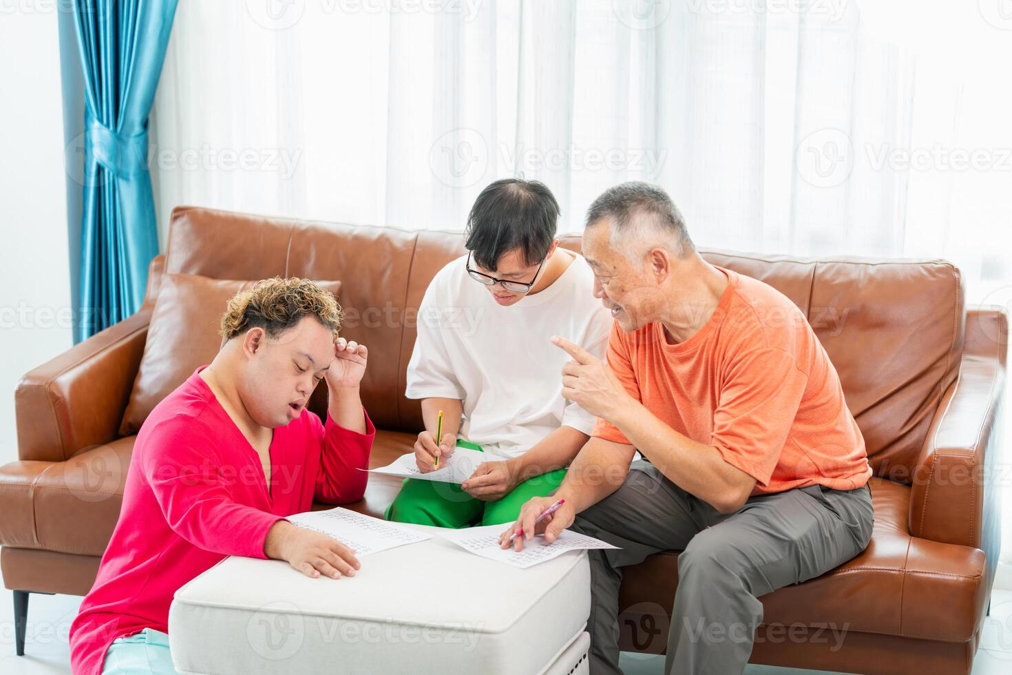 Senior man and grandchild practice math skill, interactive math game, Grandfather supervising grandchild sitting at sofa doing homework photo