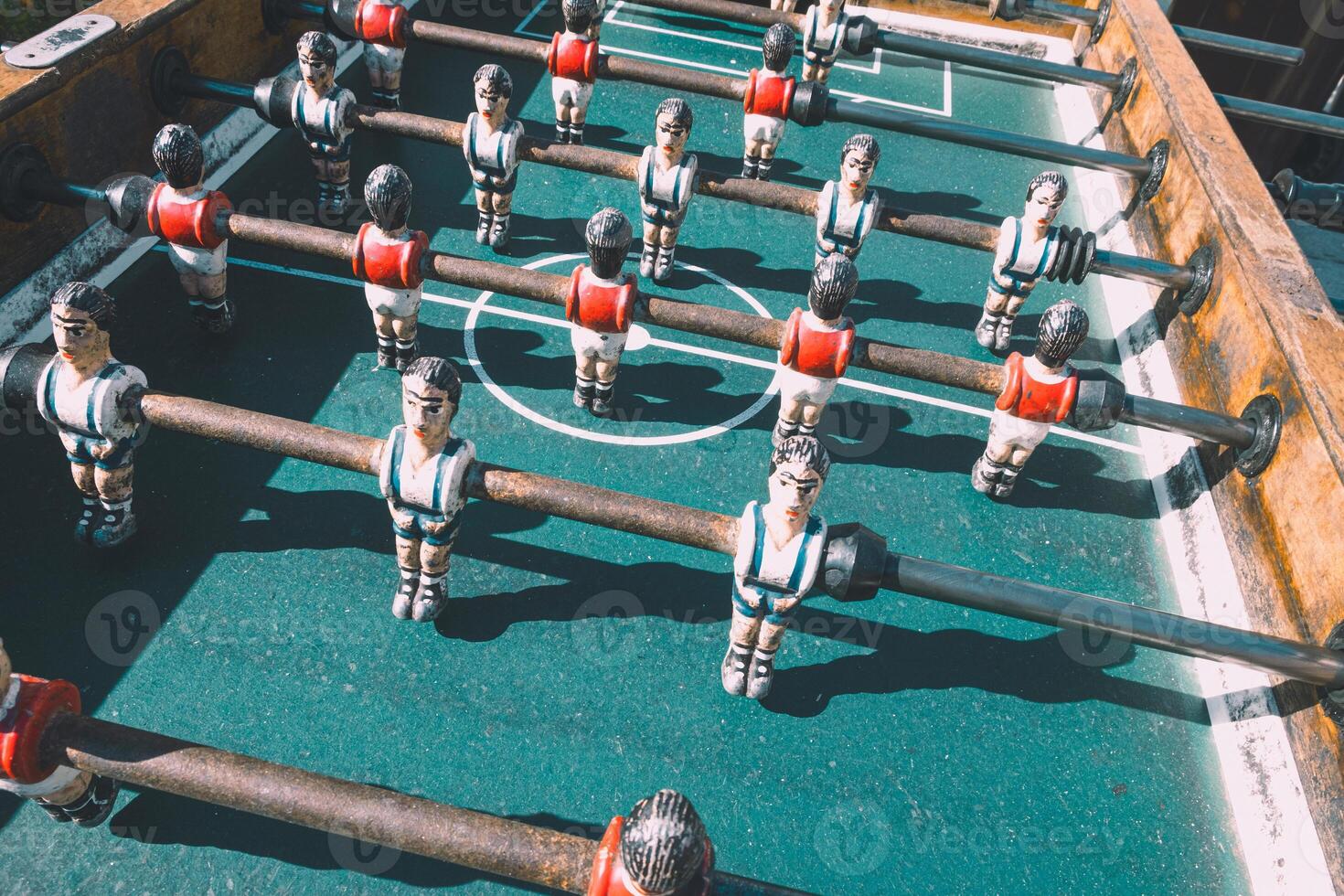 close-up view of the table football game of football figures on the field. foosball table soccer. Mini football players sport team photo