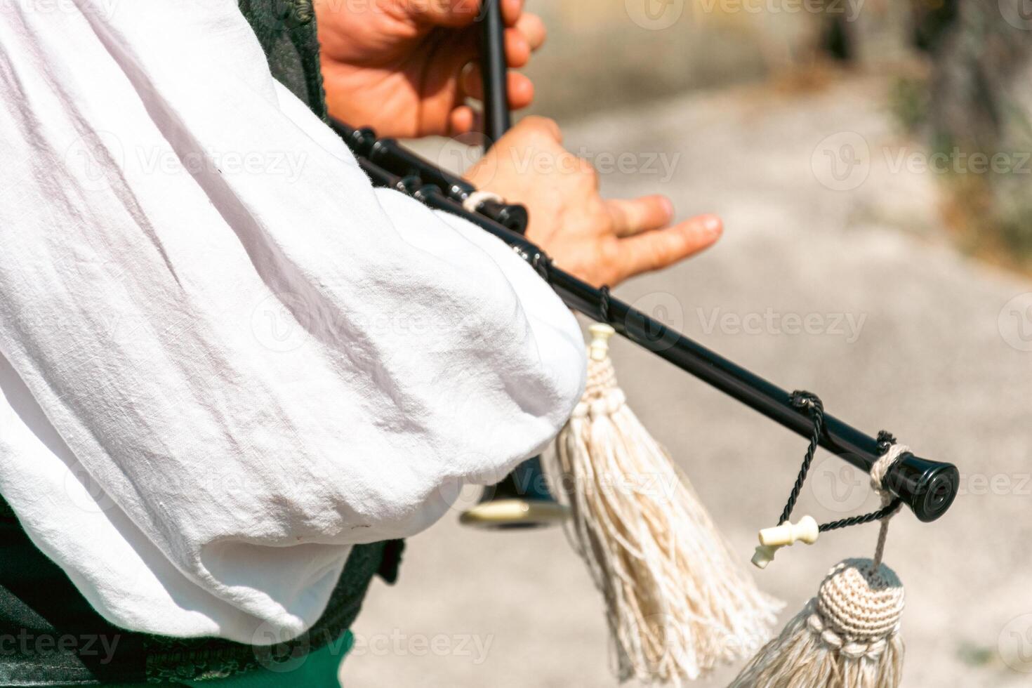 selective focus, a musician playing the typical Galicia bagpipe in a popular celebration, tradition and culture concept photo