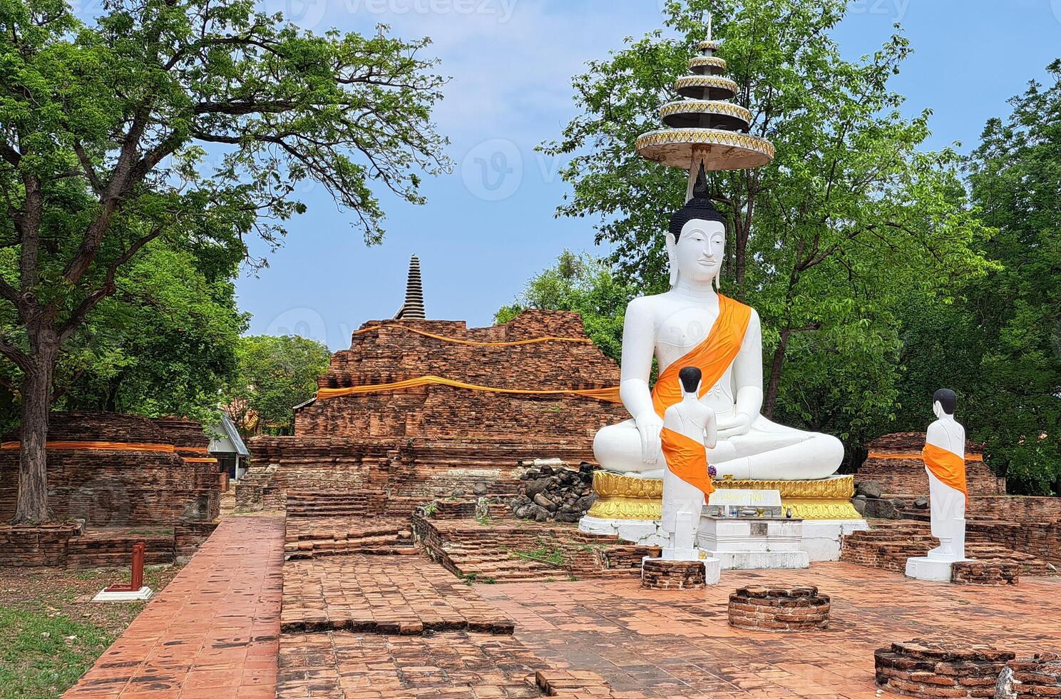 Ancient site with a large white Buddha statue photo