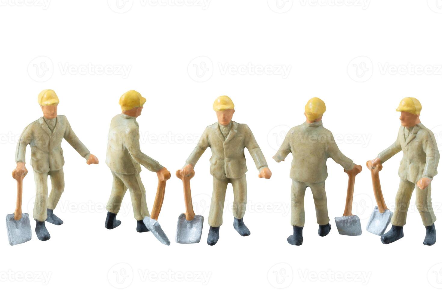 Miniature construction worker holding a shovel, isolate on white background with clipping path photo