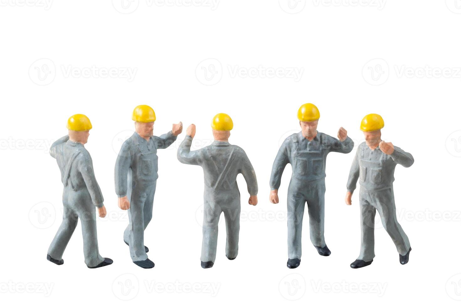 Miniature construction worker dressed in a jumpsuit isolate on white background with clipping path jumpsuit isolate on white background with clipping path photo