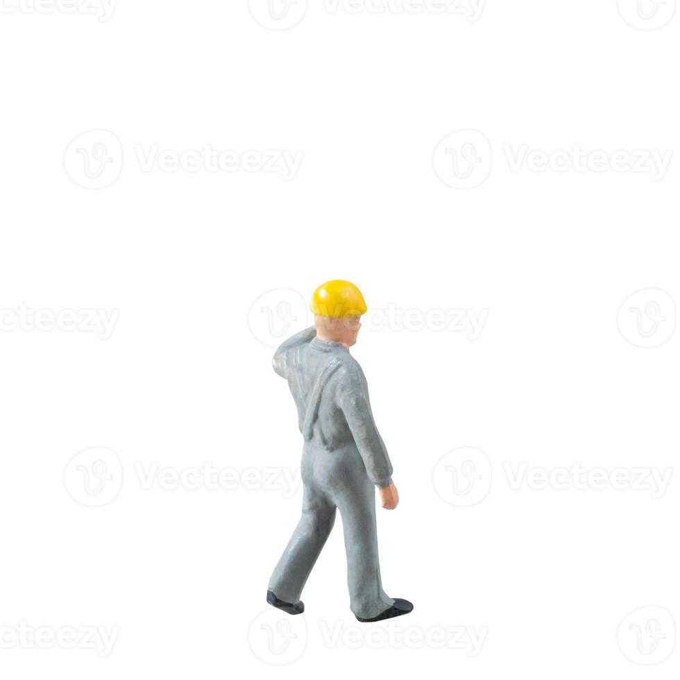 Miniature construction worker dressed in a jumpsuit isolate on white background with clipping path jumpsuit isolate on white background with clipping path photo