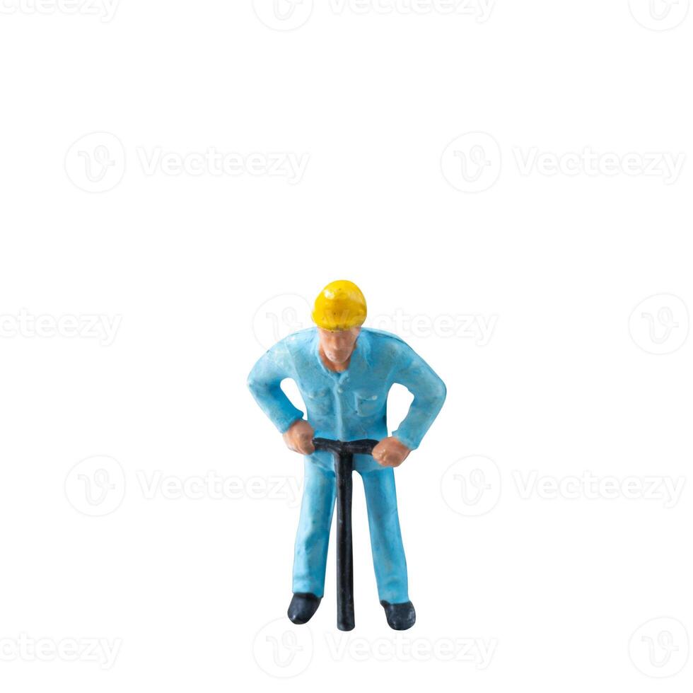 Miniature construction worker in a blue uniform isolate on white background with clipping path photo