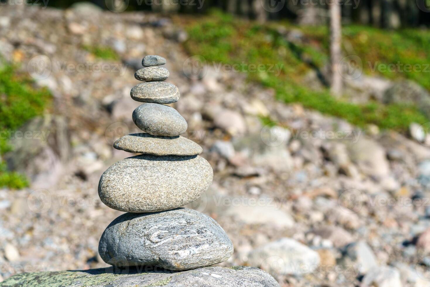 Pyramid of stones. Unstable balance of stone objects. Idyllic state of nature. photo