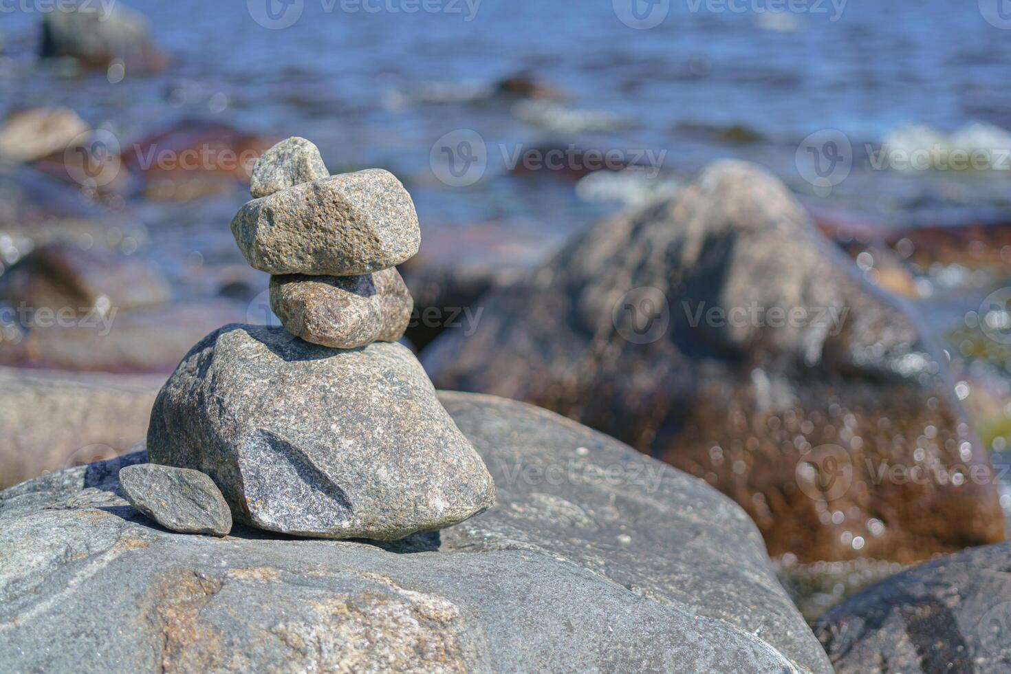Stacked Rocks balancing, stacking with precision. Stone tower on the shore. Copy space photo