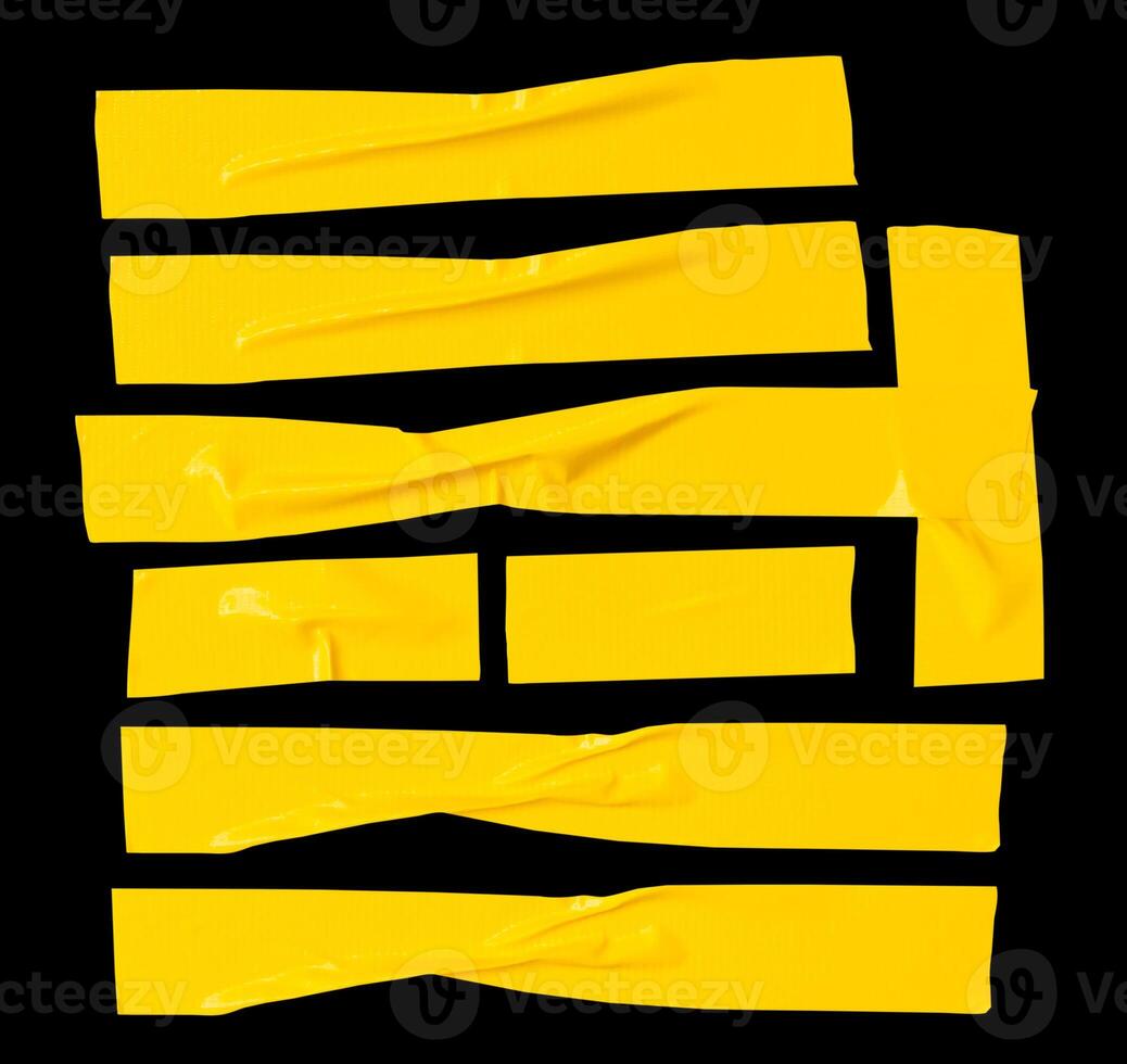 Top view set of wrinkled or crumpled yellow adhesive vinyl tape or cloth tape in stripes shape isolated on black background with clipping path photo