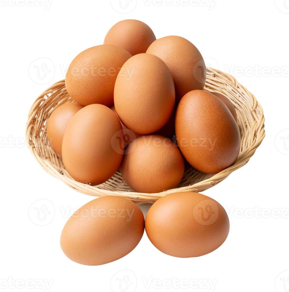 Top view of group of fresh brown chicken eggs in stack in wicker basket isolated on white background with clipping path. photo