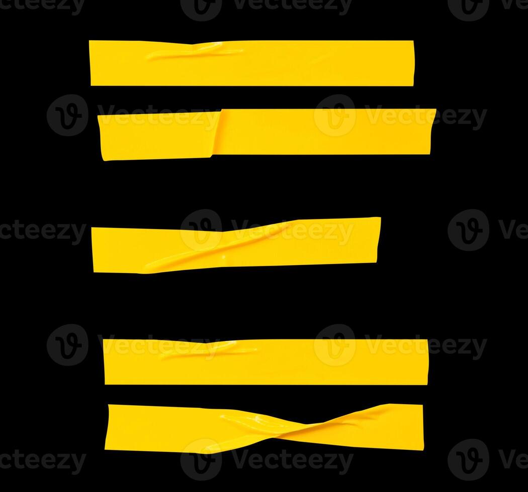 Top view set of wrinkled or crumpled yellow adhesive vinyl tape or cloth tape in stripes shape isolated on black background with clipping path photo