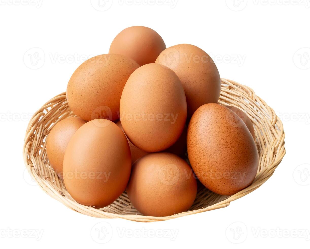 Top view of group of fresh brown chicken eggs in stack in wicker basket isolated on white background with clipping path photo