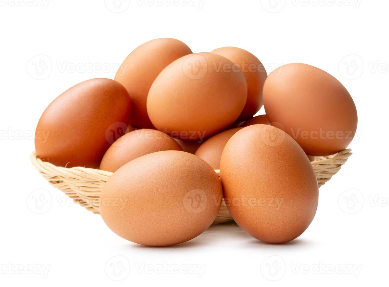 Group of fresh brown chicken eggs in stack in wicker basket isolated on white background with clipping path photo
