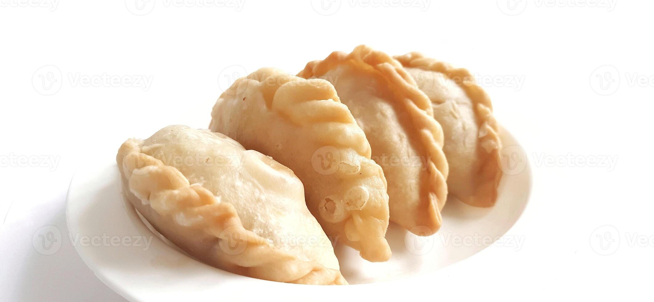 Jalangkote or pastel cake is Indonesian traditional snack food filled with egg, carrot, potato, rice noodles. Famous culinary from Makassar, South Sulawesi. Ready to eat photo