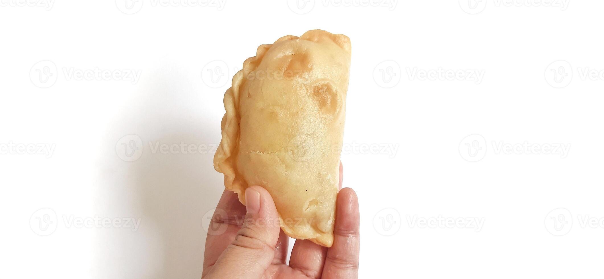 Jalangkote or pastel cake is Indonesian traditional snack food filled with egg, carrot, potato, rice noodles. Famous culinary from Makassar, South Sulawesi. Ready to eat photo