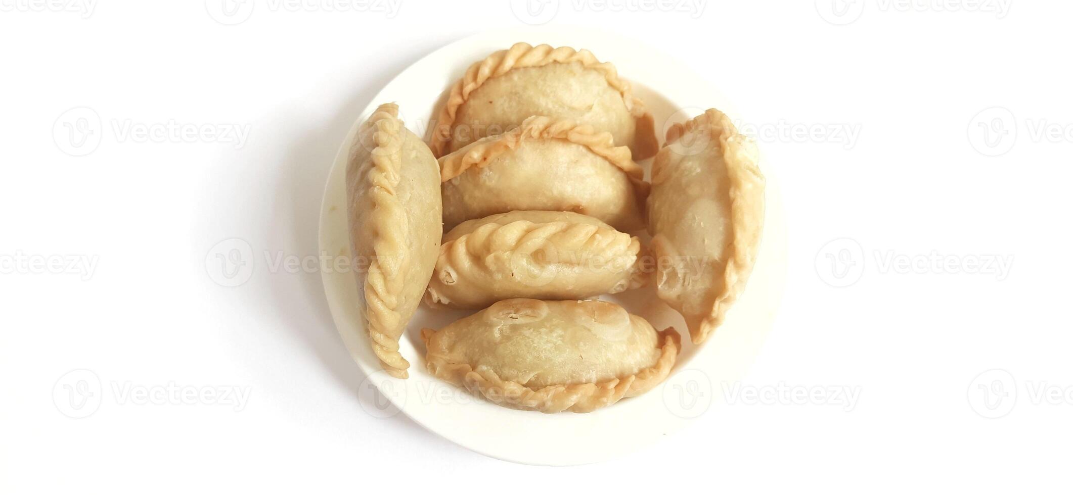Jalangkote or pastel cake is Indonesian traditional snack food filled with egg, carrot, potato, rice noodles. Famous culinary from Makassar, South Sulawesi. Ready to eat photo
