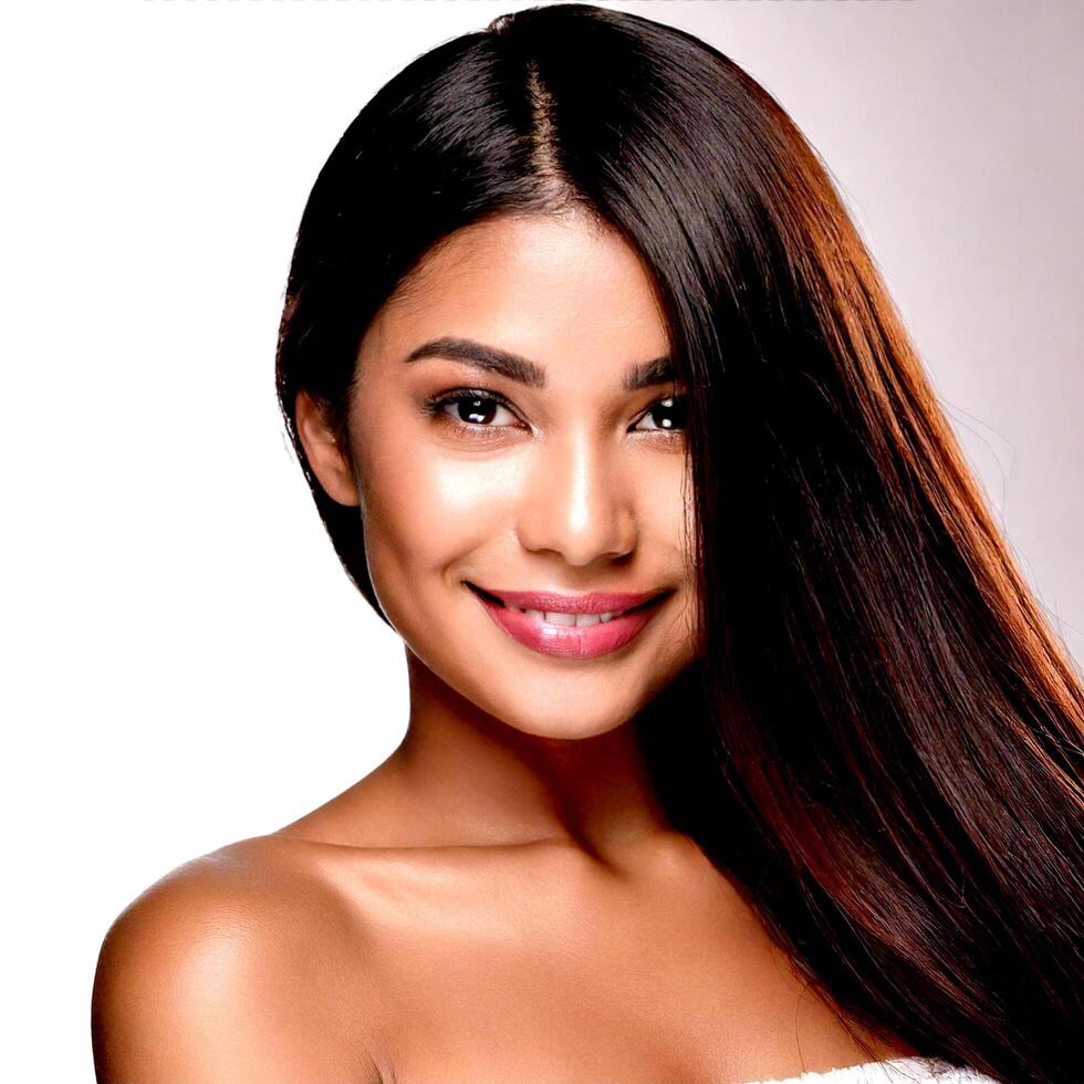 A woman with long hair smiling and wearing a white towel photo