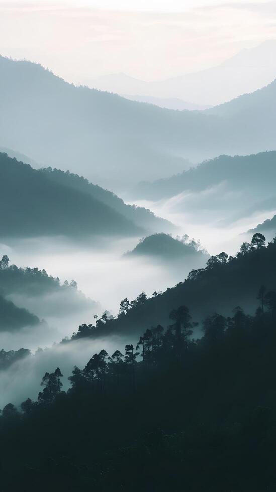 Misty Mountain Landscape at Dawn with Soft Layers and Gentle Fog photo