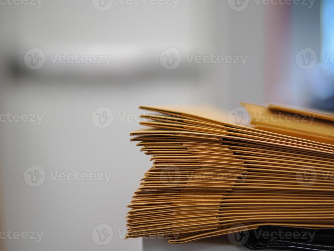 Stack of big brown envelopes on the table, many jobs waiting to be done on the table, busy concept photo