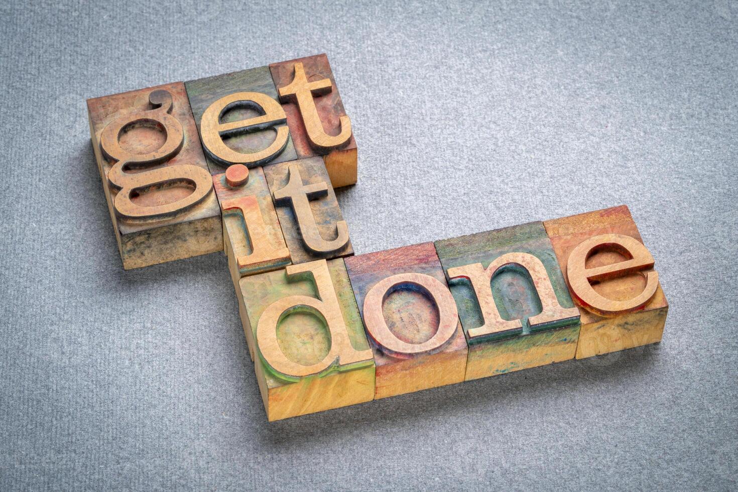 get it done - motivational advice or reminder, text in retro letterpress wood type, productivity concept photo