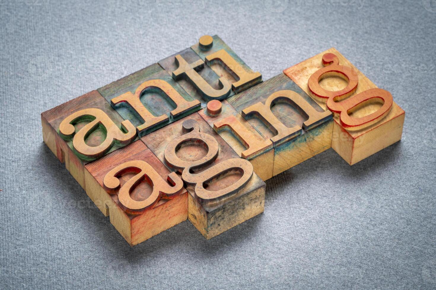 anti aging - text in retro letterpress wood type stained by color inks, lifestyle concept photo