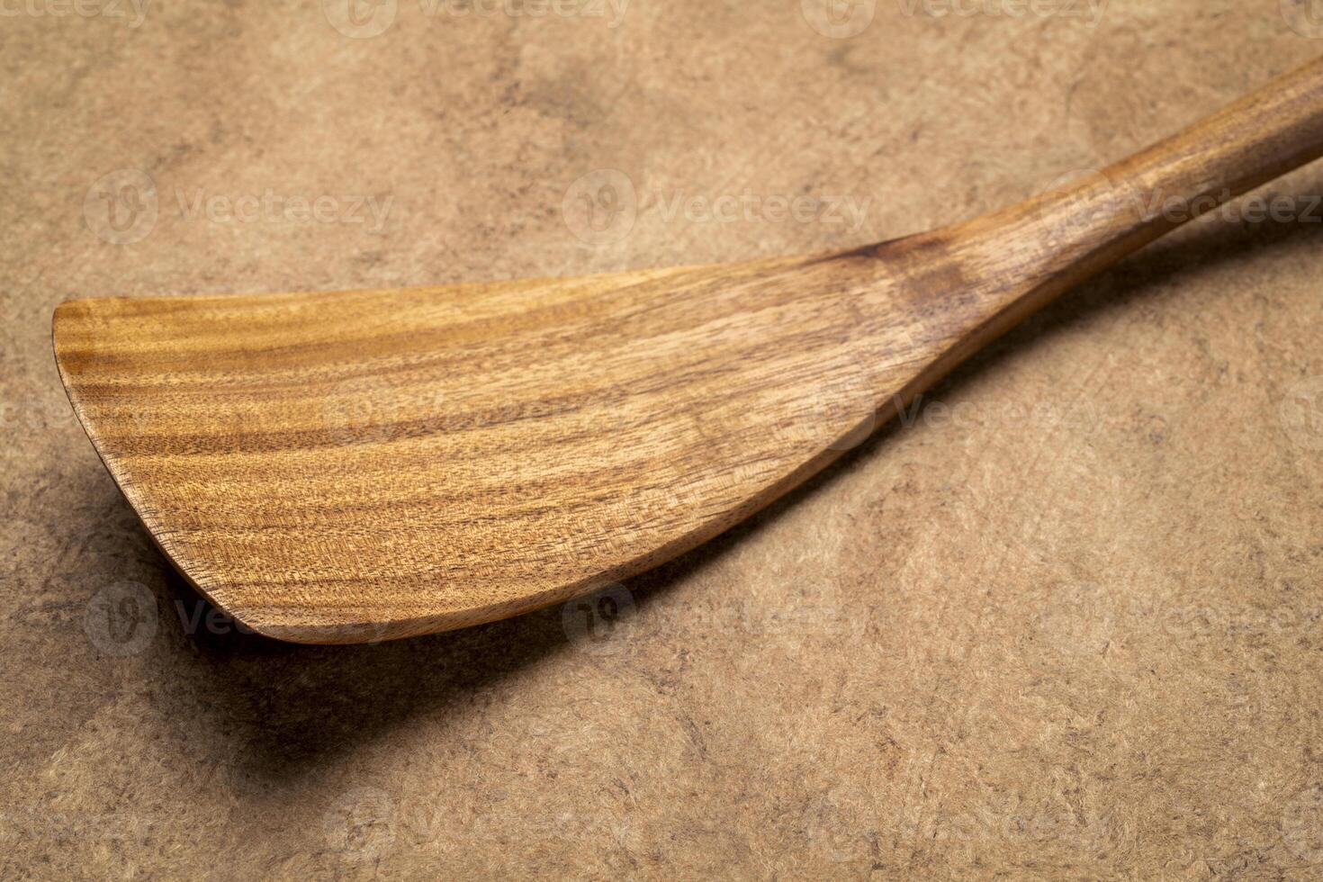 spatula - wooden kitchen cooking utensils on textured bark paper photo