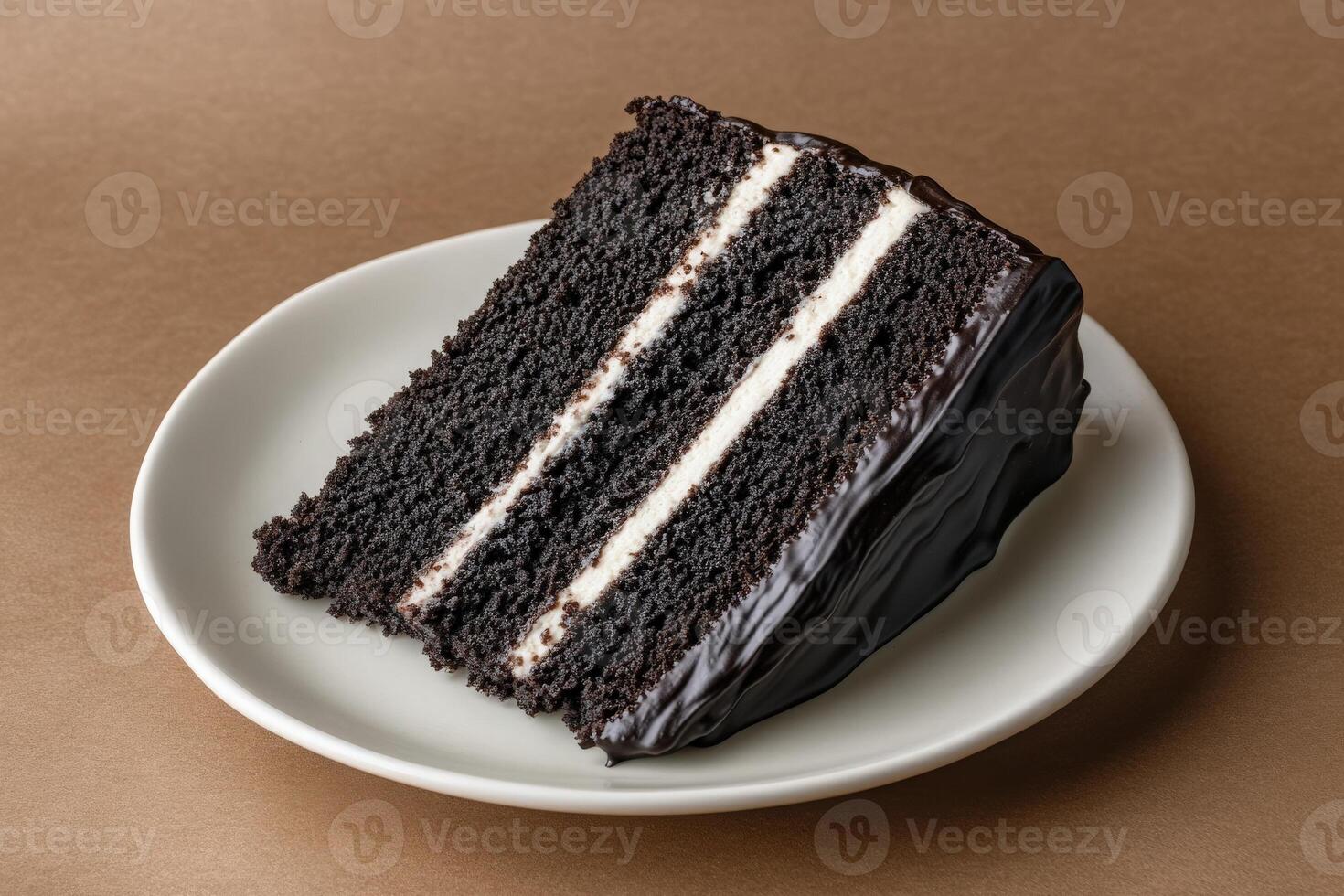 An inviting slice of rich chocolate cake sits on a white plate, showcasing layers of decadent chocolate and creamy frosting. Perfect for dessert lovers seeking indulgence. photo