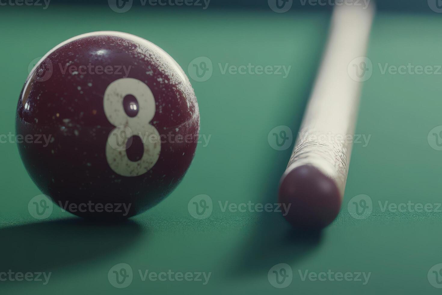 An isolated snooker ball is positioned beside a cue stick on a green felt table, creating a calm and focused atmosphere perfect for a game. The room is dimly lit, enhancing the tranquil mood. photo
