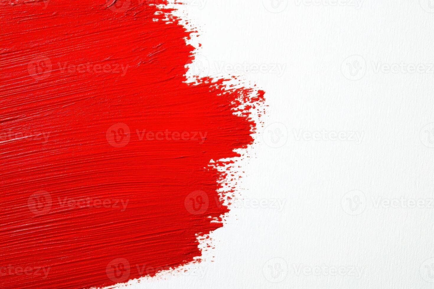 Vivid red brush strokes are applied to a pristine white canvas, showcasing an abstract art style. The bold strokes create a striking visual impact and emphasize color contrast. photo