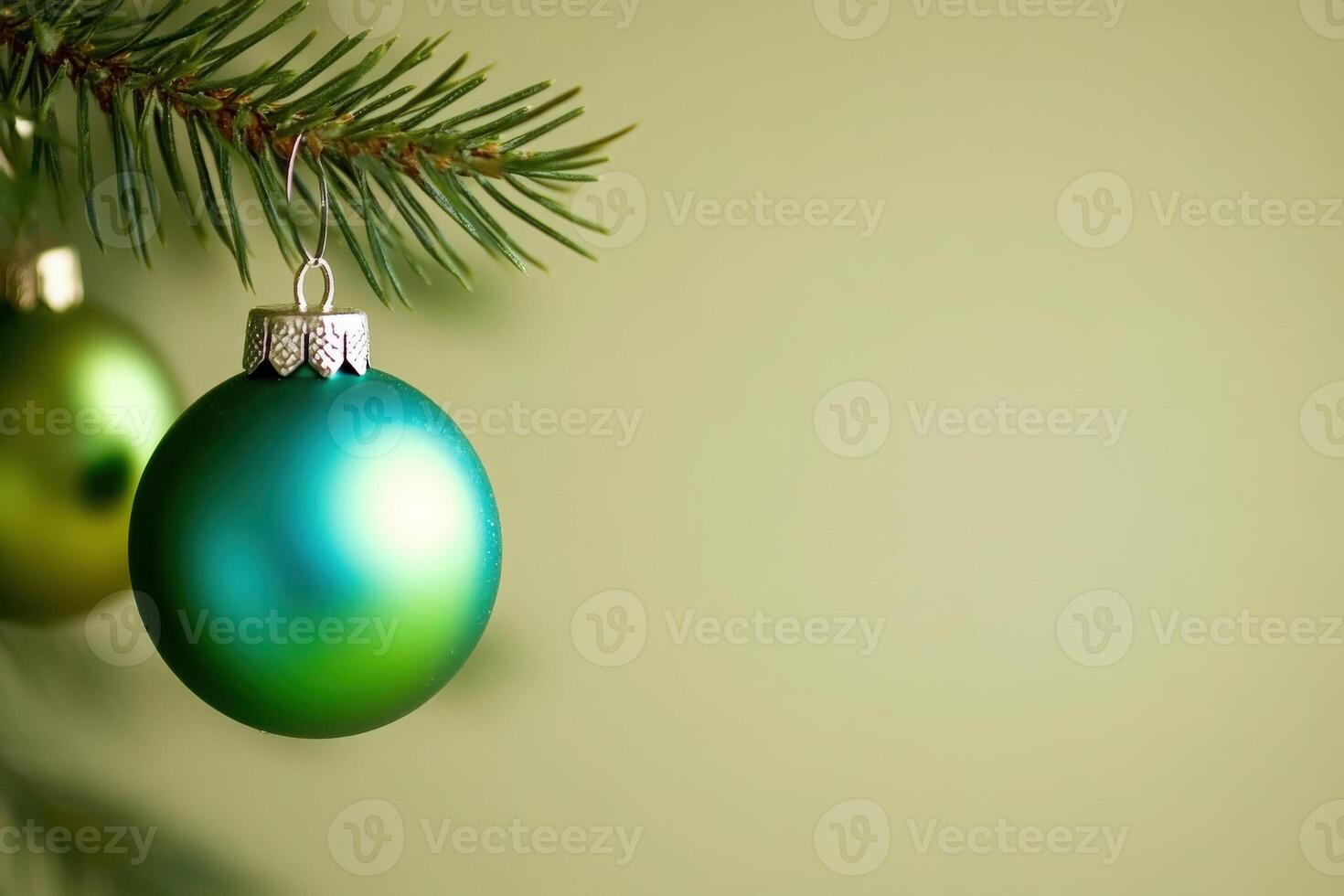 A beautiful Christmas ornament in shades of green and blue dangles from a lush tree branch, set against a soft green backdrop. The scene captures the festive spirit of the holiday season. photo