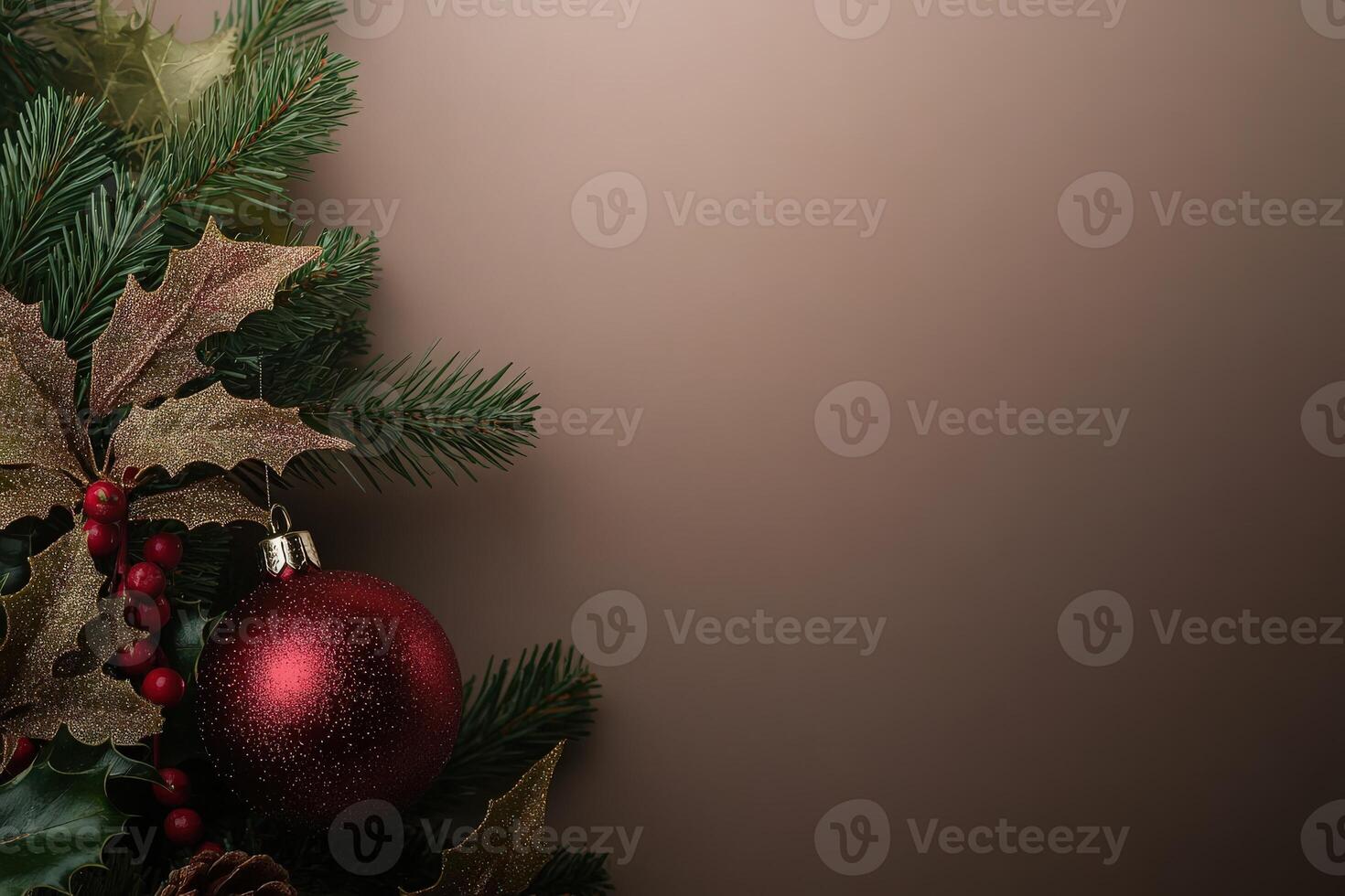 A collection of vibrant Christmas tree ornaments is carefully placed among lush evergreen branches and holly leaves, creating a festive atmosphere perfect for the holiday season. photo