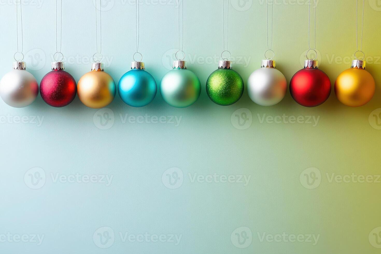 A collection of vibrant Christmas tree ornaments hangs in a row, showcasing various colors and finishes. The clean backdrop highlights the festive spirit and seasonal charm of holiday decorations. photo