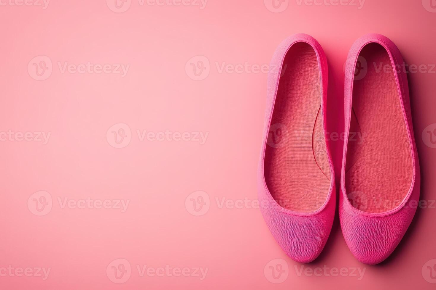 These chic ballet flats, displayed in a vibrant pink color, showcase a minimalist design ideal for casual wear. The clean solid background emphasizes their stylish appeal and versatility. photo