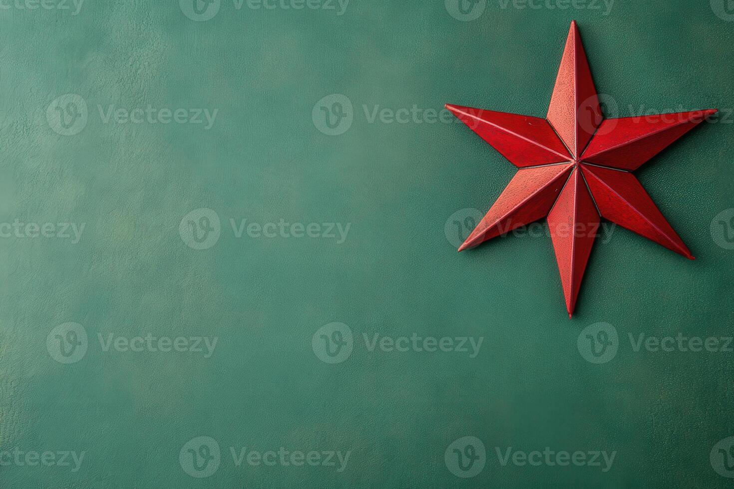 A vibrant red star is placed against a smooth green backdrop, embodying the spirit of Christmas and adding festive charm to the setting. This decoration highlights holiday joy beautifully. photo
