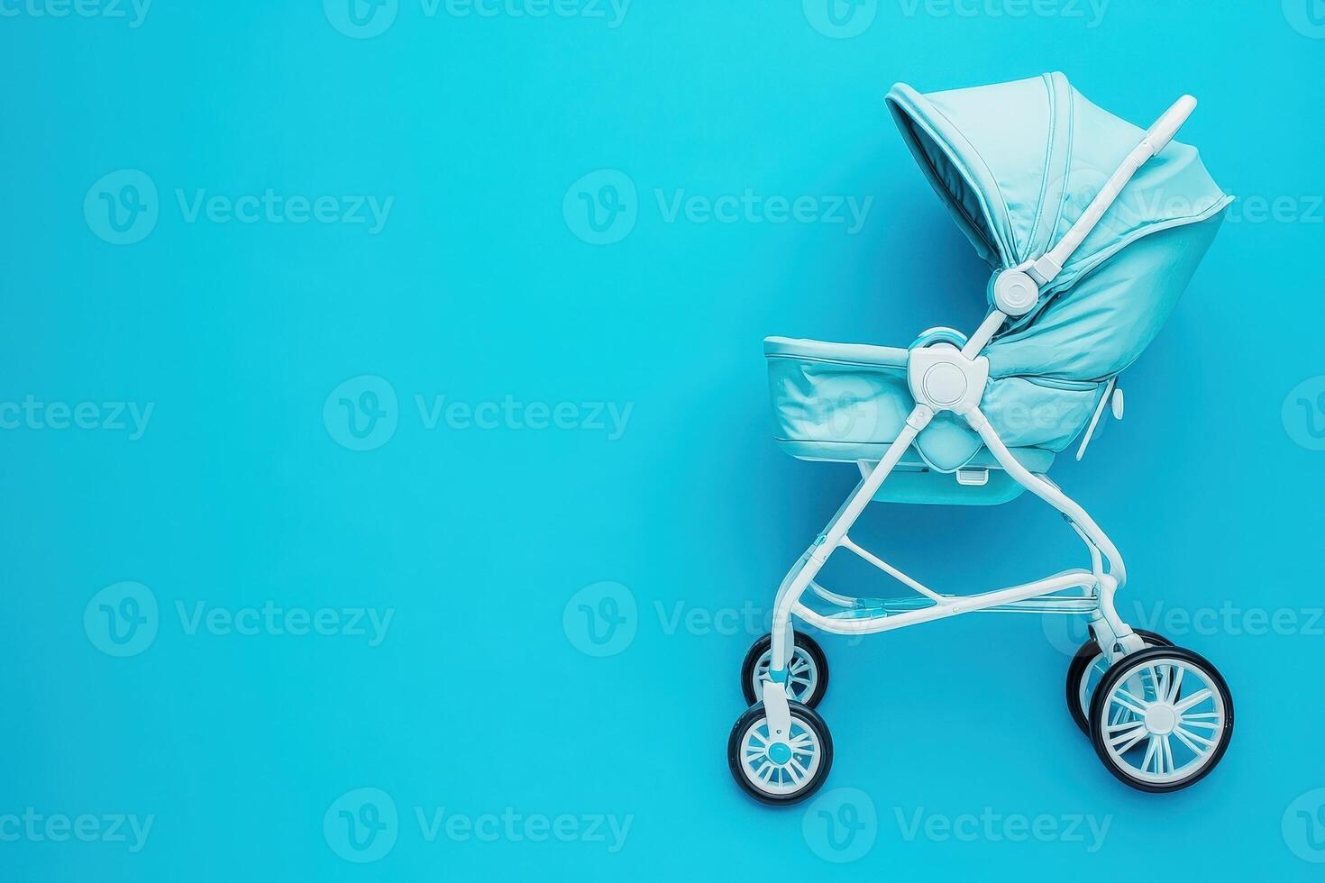 A compact baby buggy stands out on a solid blue background, showcasing its sleek design and practical features. photo