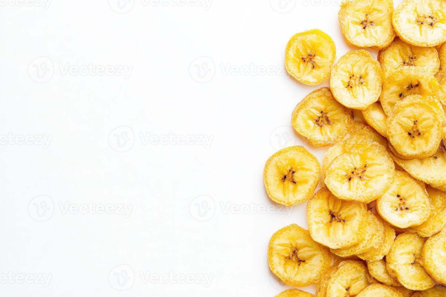 Brightly colored dried banana chips are neatly placed on a clean white surface, showcasing their crunchy texture and natural sweetness. Ideal for snacking or adding to recipes. photo