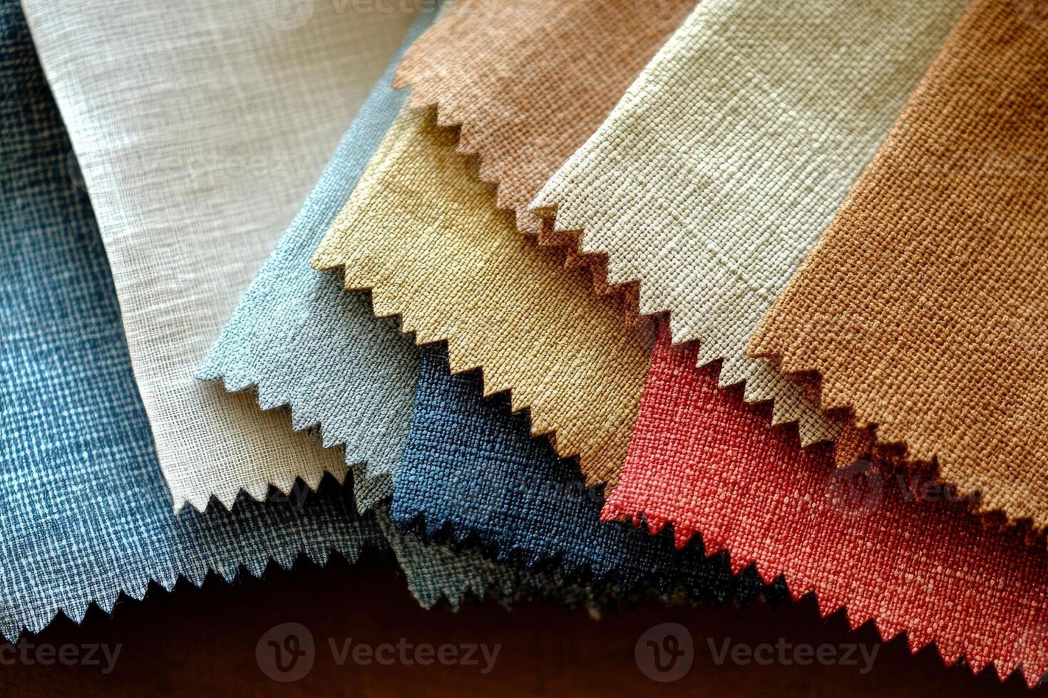 A collection of fabric swatches featuring solid colors and a clean, minimalist design is spread across a flat surface. The swatches vary in texture and hue, creating a harmonious visual appeal. photo