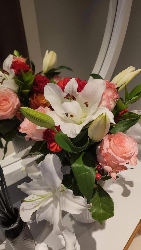 Wedding bouquet with roses and lilies on the table photo